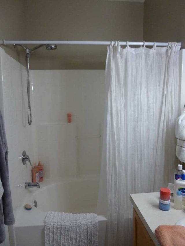 bathroom with vanity and shower / bathtub combination with curtain