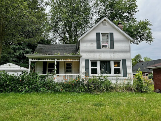 view of front of property with covered porch and a front lawn