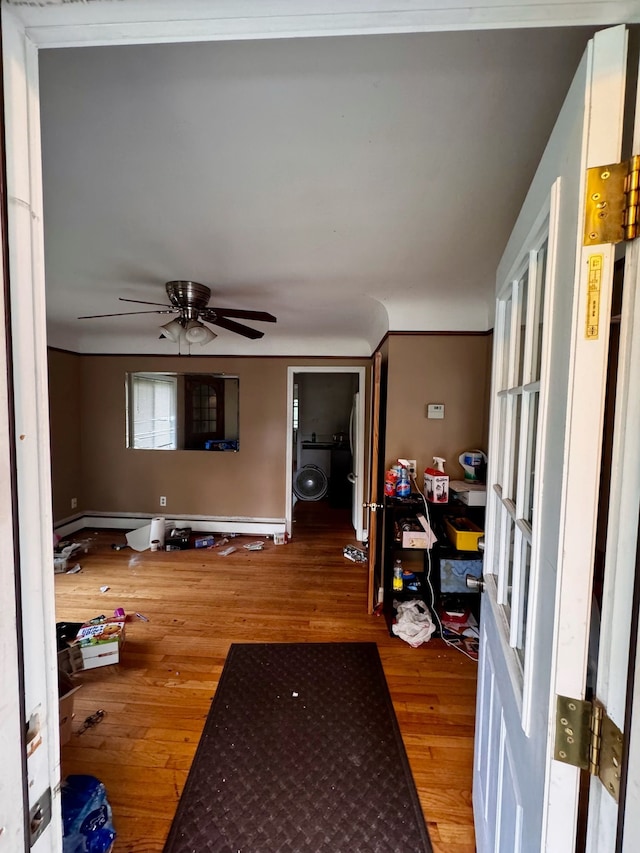 living room featuring wood-type flooring and ceiling fan