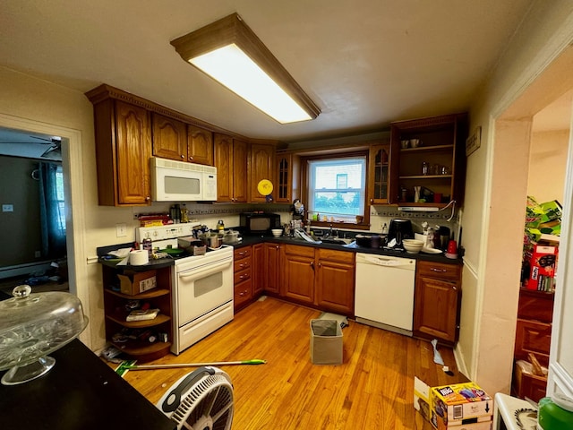 kitchen with white appliances, sink, and light hardwood / wood-style flooring