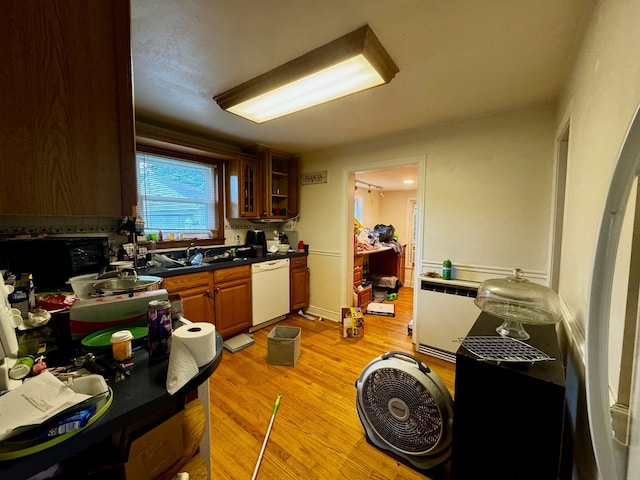 kitchen with white dishwasher and light hardwood / wood-style flooring