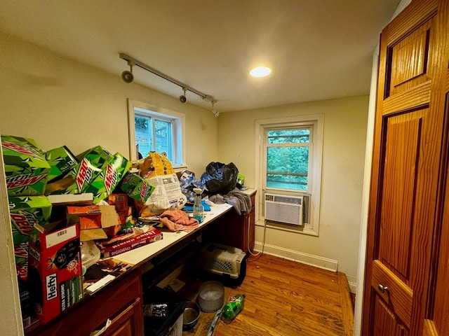 misc room with a wealth of natural light, cooling unit, and wood-type flooring