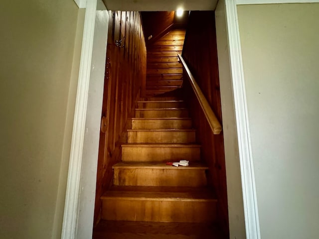 stairs with wood walls