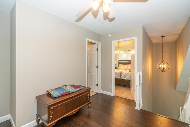609 3rd St, Muskegon, MI 49445 - hall featuring a chandelier, dark wood-style floors, and baseboards