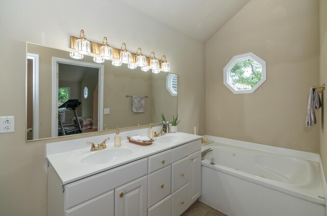 609 3rd St, Muskegon, MI 49445 - full bath featuring double vanity, healthy amount of natural light, a jetted tub, and vaulted ceiling