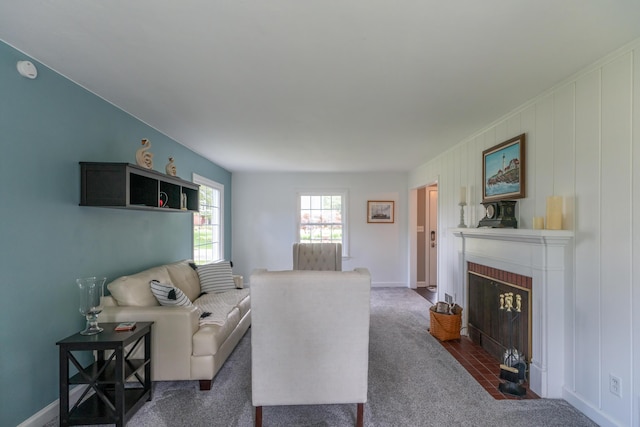 609 3rd St, Muskegon, MI 49445 - living room featuring dark colored carpet and a fireplace