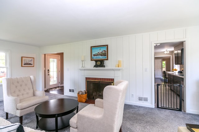 609 3rd St, Muskegon, MI 49445 - carpeted living area with a brick fireplace