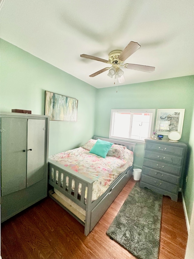 bedroom featuring ceiling fan and dark hardwood / wood-style flooring