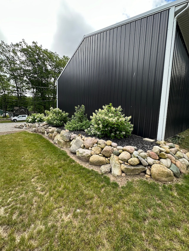 view of side of home with a lawn