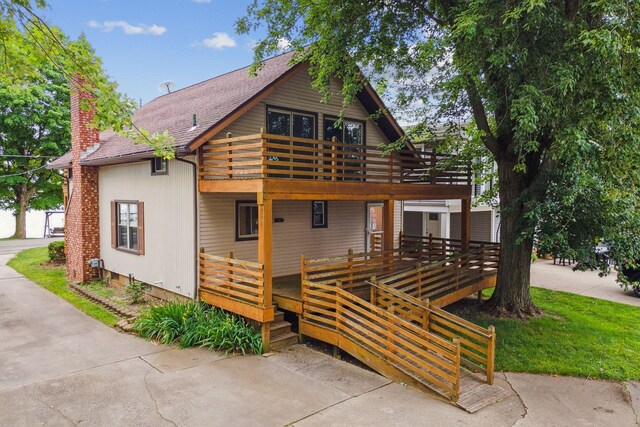 2973 Round Lake Hwy, Manitou Beach, MI 49253 - view of front of property with a chimney, a balcony, and roof with shingles