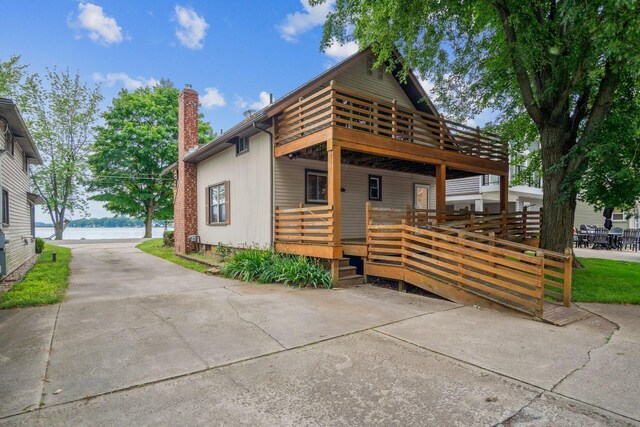 exterior space with a deck with water view