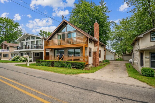 2973 Round Lake Hwy, Manitou Beach, MI 49253 - view of front of property featuring a chimney, a balcony, and an outbuilding