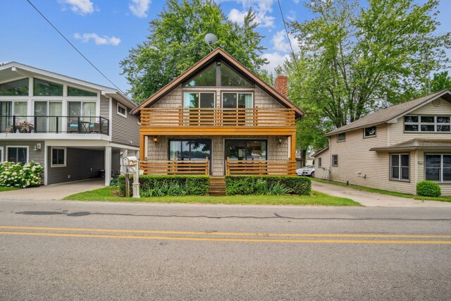 2973 Round Lake Hwy, Manitou Beach, MI 49253 - log-style house featuring a chimney, driveway, and covered porch