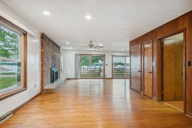 2973 Round Lake Hwy, Manitou Beach, MI 49253 - unfurnished living room featuring healthy amount of natural light, a ceiling fan, light wood finished floors, and recessed lighting
