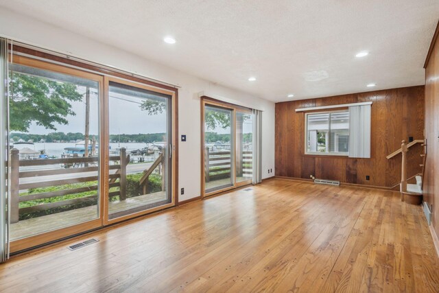 2973 Round Lake Hwy, Manitou Beach, MI 49253 - unfurnished room with healthy amount of natural light, baseboards, light wood-type flooring, recessed lighting, and a water view