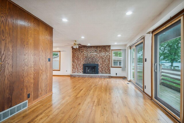 2973 Round Lake Hwy, Manitou Beach, MI 49253 - unfurnished living room featuring light wood-style floors, a brick fireplace, recessed lighting, and ceiling fan