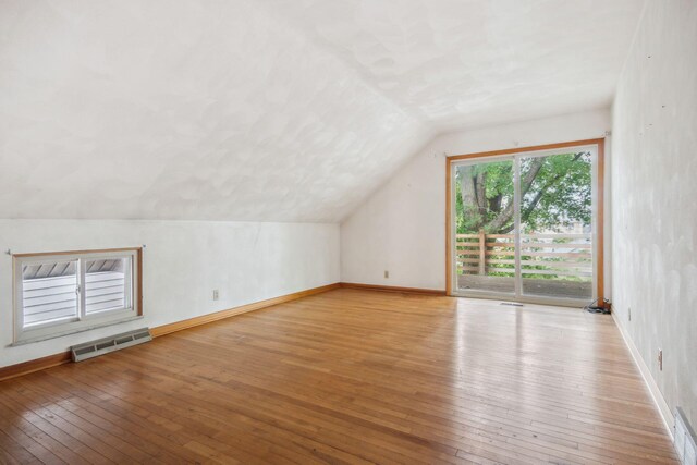 2973 Round Lake Hwy, Manitou Beach, MI 49253 - bonus room featuring lofted ceiling, wood-type flooring, and baseboards