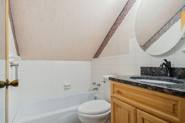 2973 Round Lake Hwy, Manitou Beach, MI 49253 - bathroom featuring a tub to relax in, toilet, vanity, and tile walls