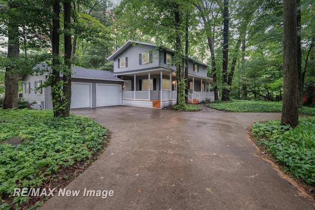 front of property with a porch and a garage