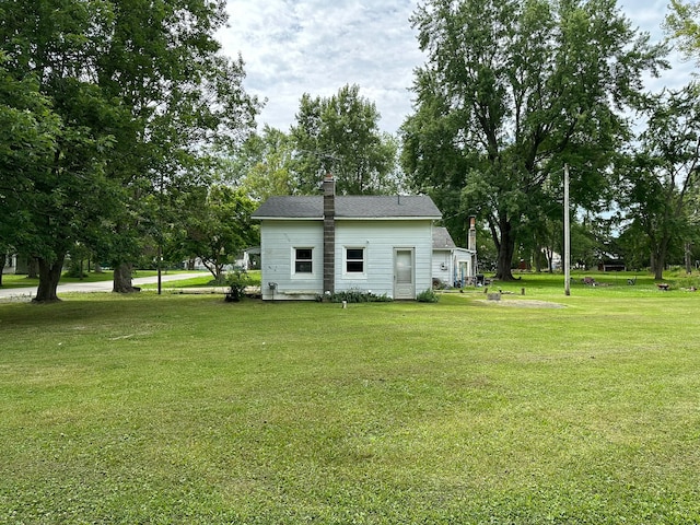 back of property featuring a yard