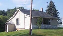 rear view of property with a lawn