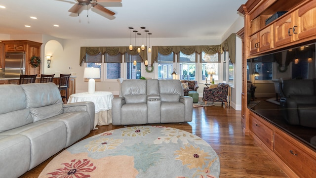 740 Greystone Dr, Chelsea, MI 48118 - living room featuring arched walkways, dark wood finished floors, recessed lighting, a ceiling fan, and baseboards