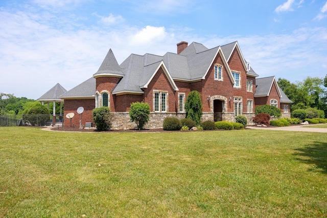 740 Greystone Dr, Chelsea, MI 48118 - view of front of house with a chimney, brick siding, and stone siding