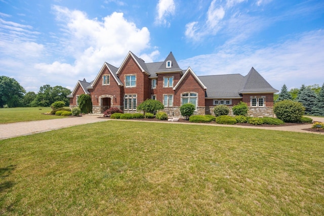 740 Greystone Dr, Chelsea, MI 48118 - view of front of house with a front lawn, stone siding, and brick siding
