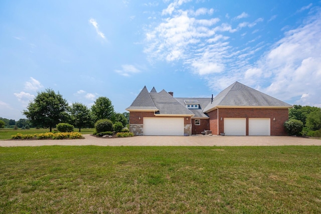 740 Greystone Dr, Chelsea, MI 48118 - view of front of house with a front lawn, decorative driveway, brick siding, and a garage