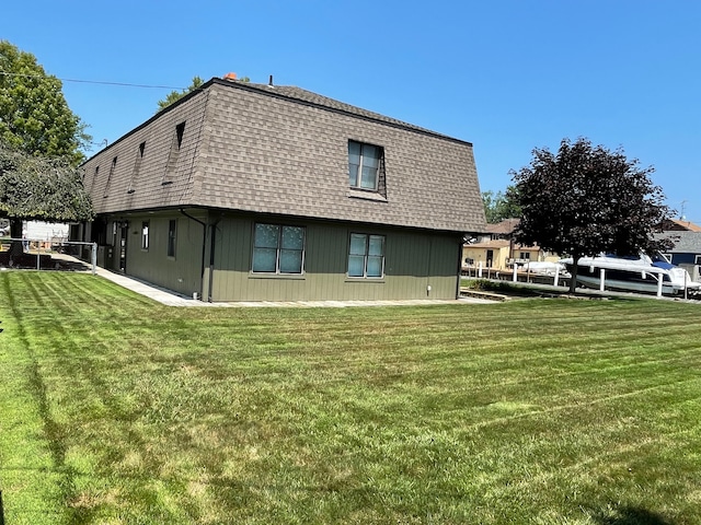 46070 Edgewater Dr, Chesterfield, MI 48047 - rear view of property with a shingled roof, mansard roof, and a yard