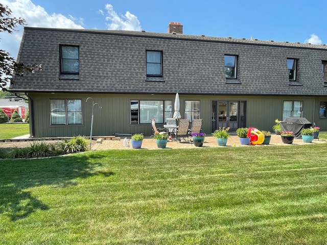 46070 Edgewater Dr, Chesterfield, MI 48047 - back of house featuring a shingled roof, mansard roof, a yard, and a chimney