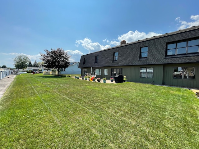 46070 Edgewater Dr, Chesterfield, MI 48047 - back of property featuring a shingled roof, a chimney, and a yard