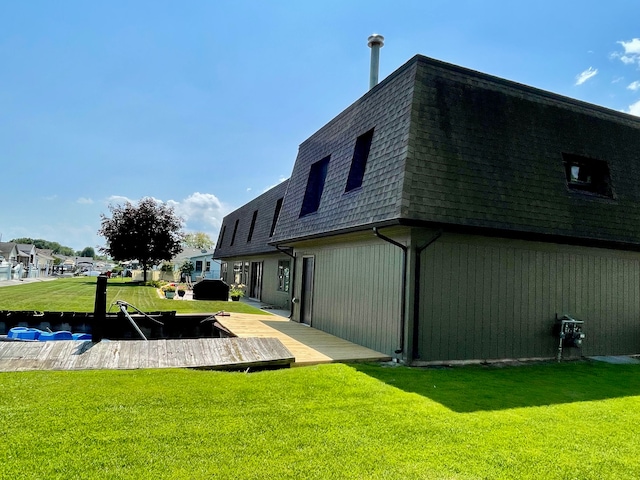 46070 Edgewater Dr, Chesterfield, MI 48047 - rear view of house featuring roof with shingles, mansard roof, and a lawn