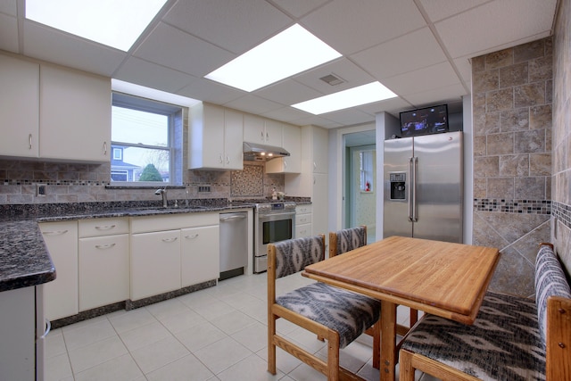 46070 Edgewater Dr, Chesterfield, MI 48047 - kitchen with appliances with stainless steel finishes, under cabinet range hood, a sink, white cabinets, and light tile patterned floors