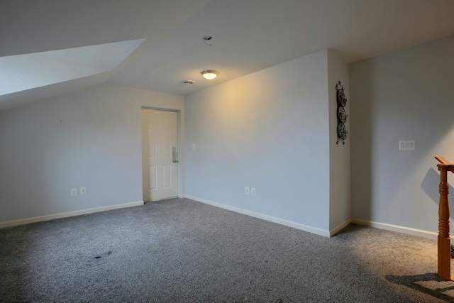 additional living space with carpet floors and vaulted ceiling