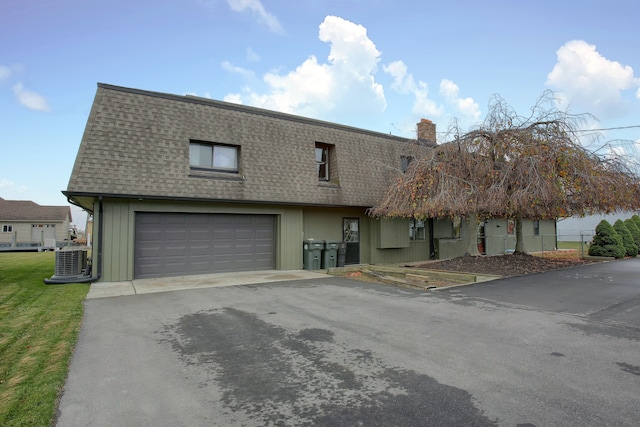 46070 Edgewater Dr, Chesterfield, MI 48047 - view of front of home featuring a shingled roof, driveway, an attached garage, and a chimney