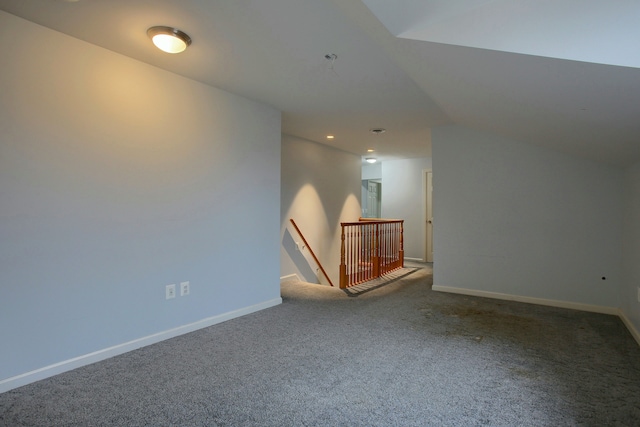 additional living space featuring carpet floors and vaulted ceiling