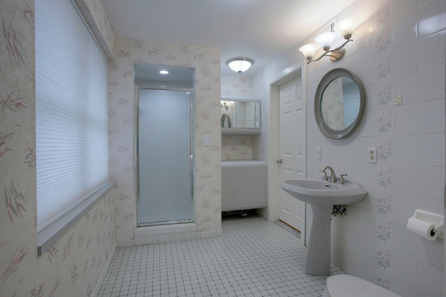 bathroom with tile patterned floors, sink, toilet, and walk in shower