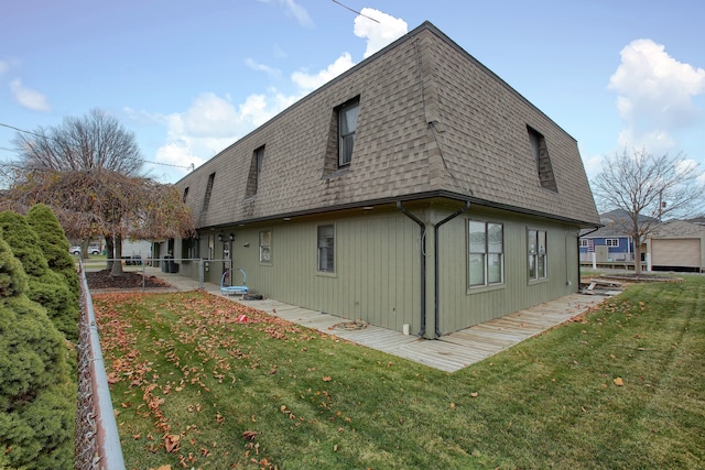 46070 Edgewater Dr, Chesterfield, MI 48047 - rear view of property featuring roof with shingles, a yard, and mansard roof