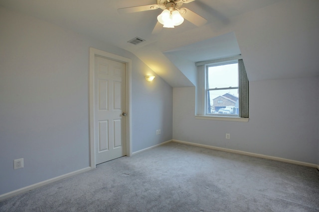 additional living space with ceiling fan, light carpet, and vaulted ceiling