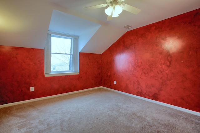 bonus room with carpet flooring, vaulted ceiling, and ceiling fan