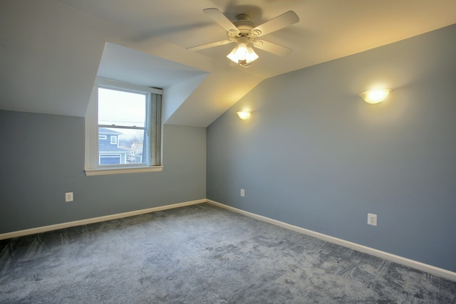 additional living space featuring carpet flooring, ceiling fan, and vaulted ceiling