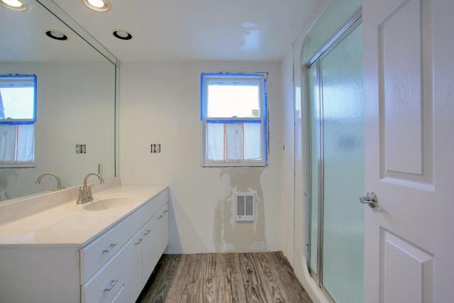 46070 Edgewater Dr, Chesterfield, MI 48047 - bathroom featuring wood finished floors, a shower stall, vanity, heating unit, and recessed lighting