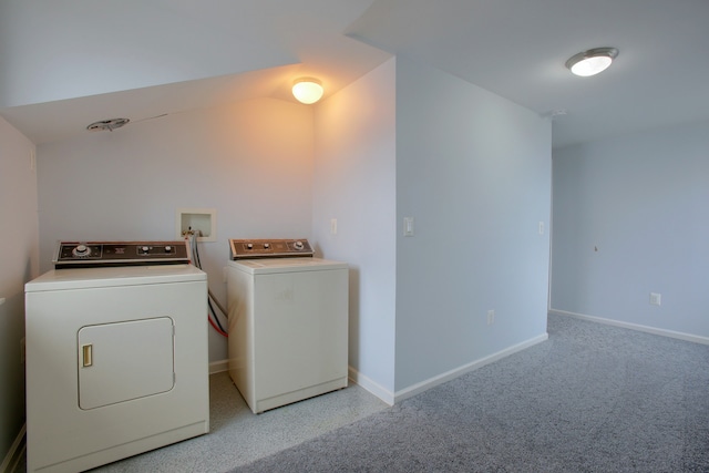 clothes washing area featuring washing machine and clothes dryer and light carpet