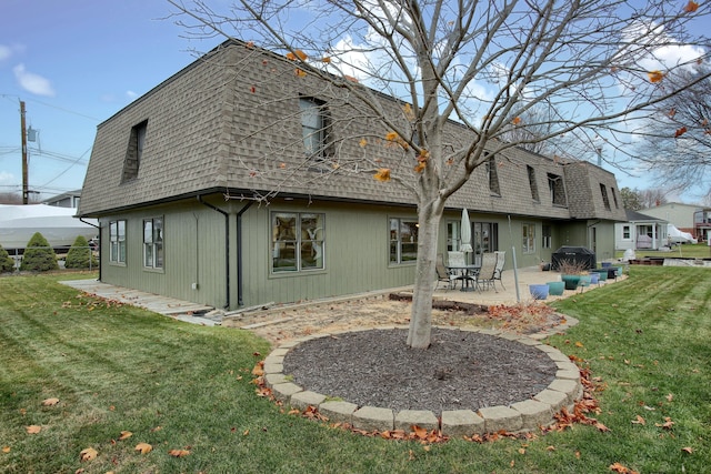 46070 Edgewater Dr, Chesterfield, MI 48047 - back of property featuring a shingled roof, mansard roof, a yard, and a patio area