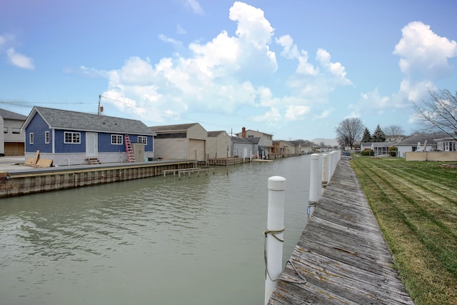 view of dock featuring a yard and a water view