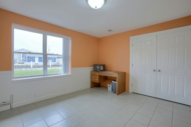 unfurnished office featuring light tile patterned flooring