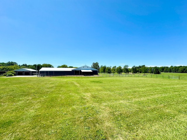 view of yard with a rural view and an outbuilding