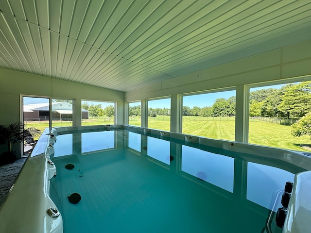 unfurnished sunroom featuring a rural view