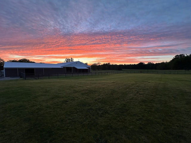 yard at dusk with a rural view